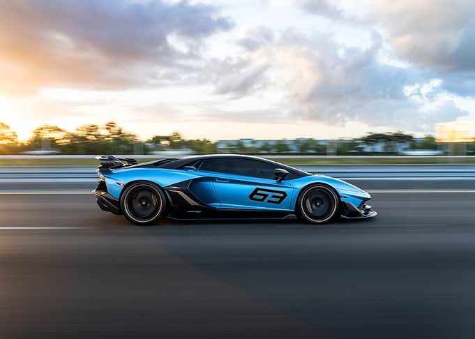Blue Lamborghini Aventador speeding on road