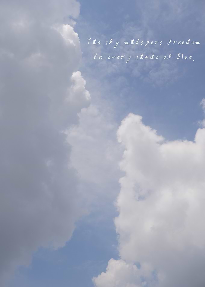 Towering clouds against a clear blue sky, an image that echoes the boundless whisper of freedom.