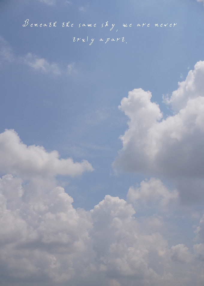 The endless sky holds soft clouds that speak of unity, reminding us we share the same horizon no matter where we are.