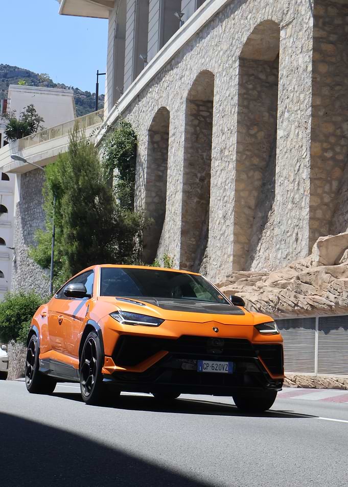 Orange Lamborghini Urus on City Street