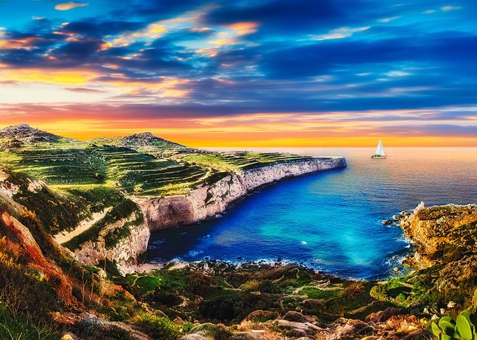 Malta Cliffs at Fomm ir-Rih with Sailboat at Sunset
