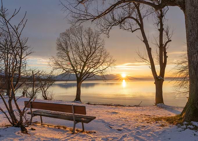 Winter Sunset Over Lake with Bench