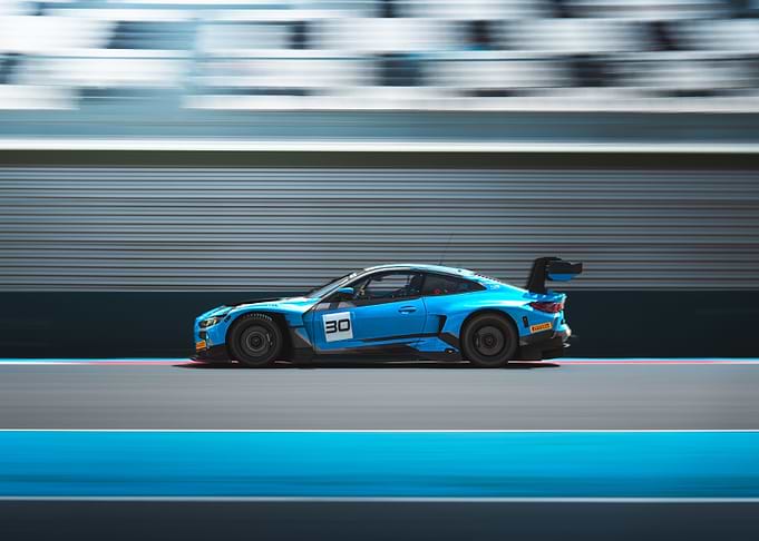 Blue Race Car Speeding on Track