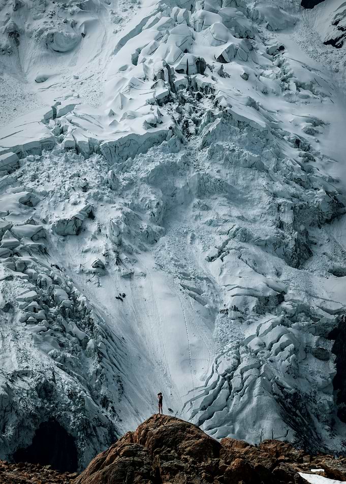 Person on rock with glacier backdrop