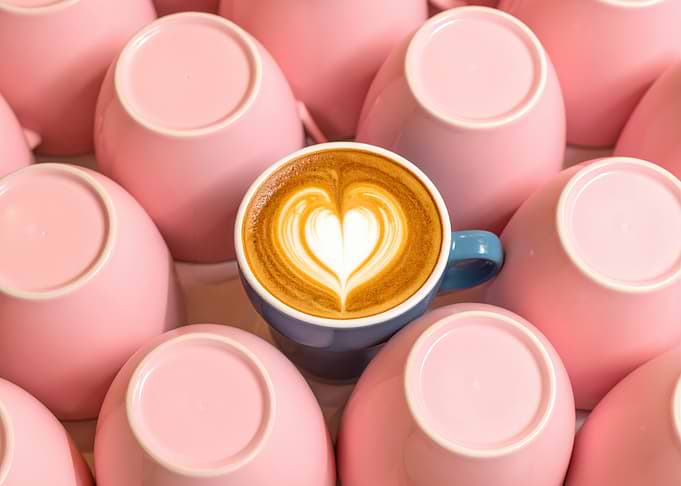 Latte Art Surrounded by Pink Cups