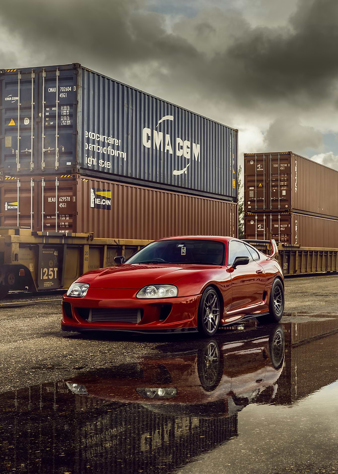 Red Toyota Supra with Shipping Containers