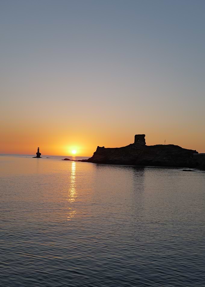 Sunset over the sea with island, Andros, Cyclades, Greece