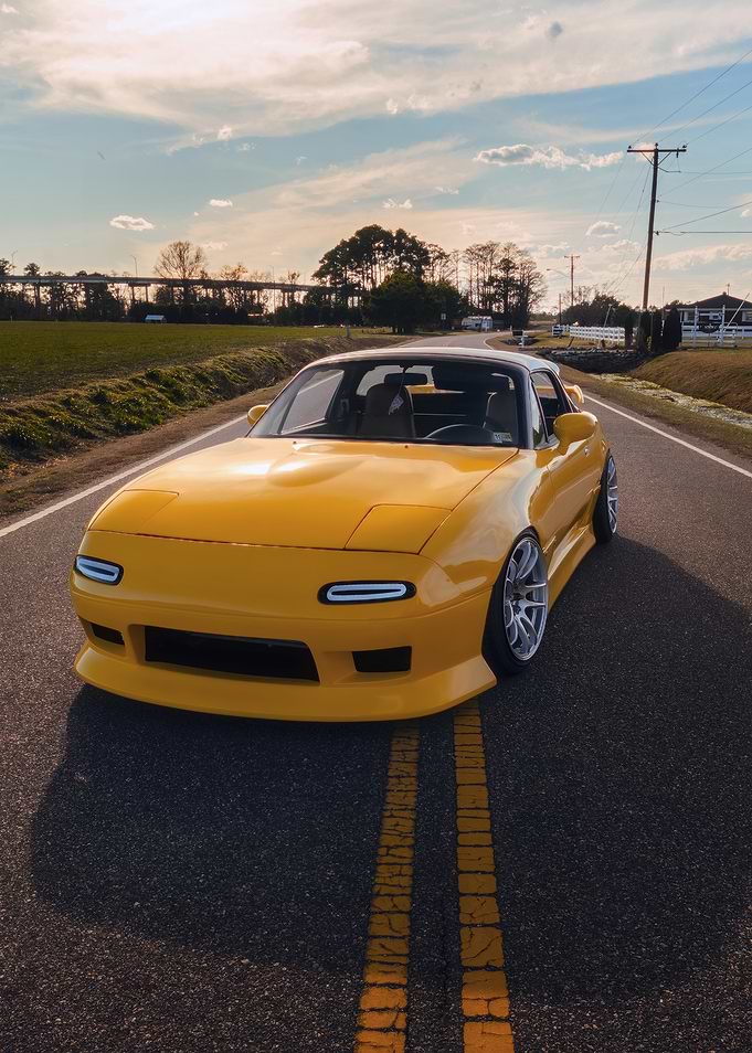 Yellow Mazda Miata on Road