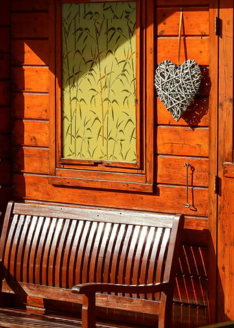 Wooden house facade with bench and decoration
