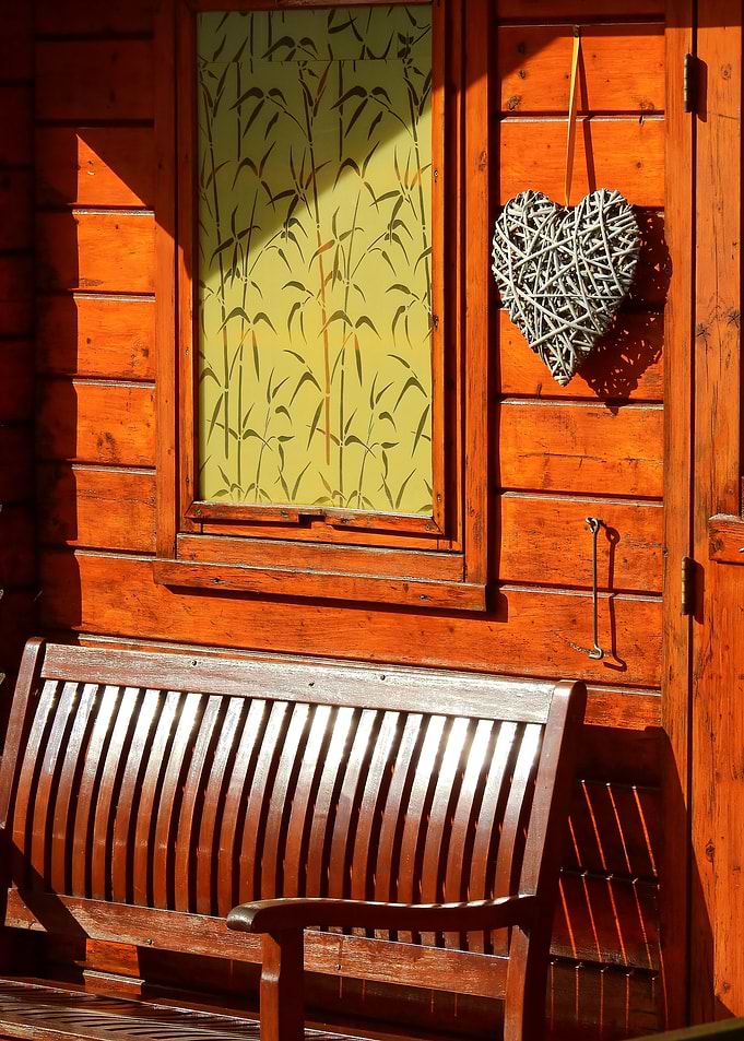 Wooden house facade with bench and decoration