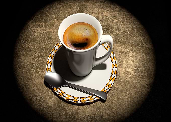 Coffee cup with spoon on saucer