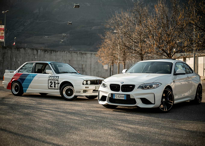 Two White BMW Cars on Asphalt