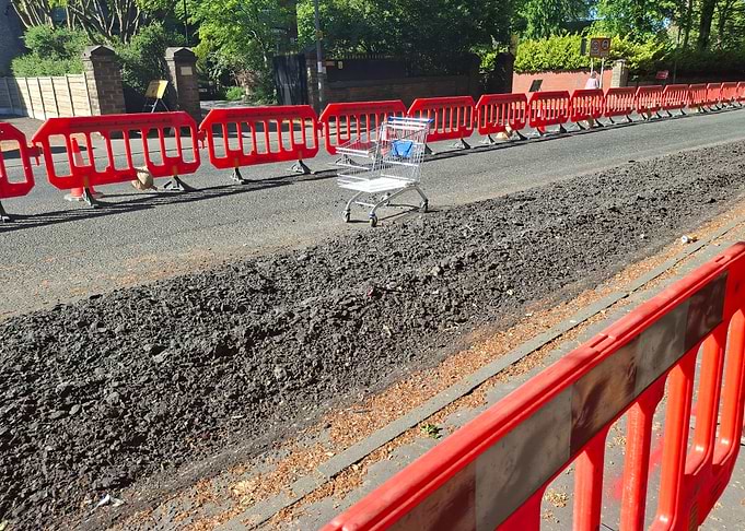 Shopping cart on road construction site