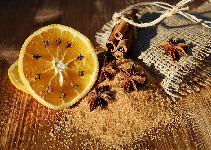 Orange slice with spices on wood