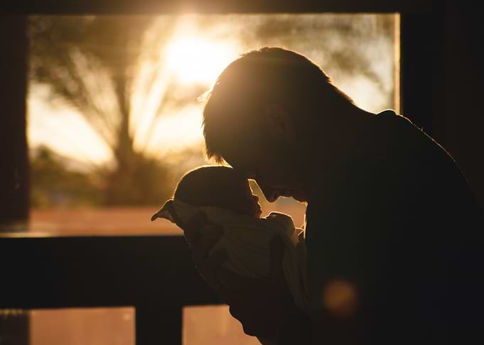 Father and Newborn Silhouette at Sunset
