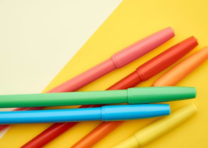 Colorful Markers on Yellow Background