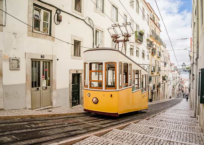 Lisbon Tram on Cobblestone Street