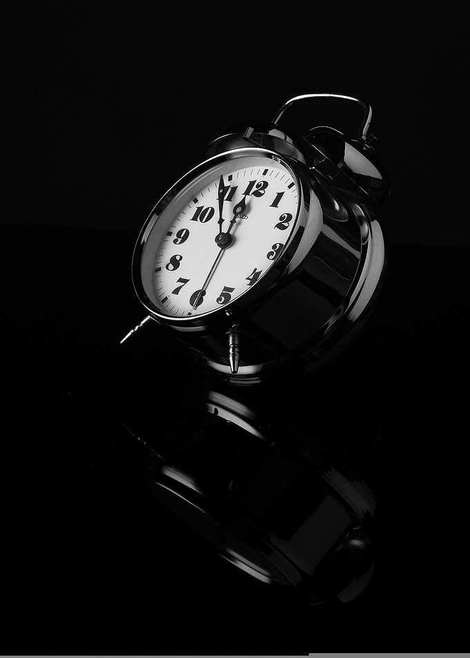 Monochrome Alarm Clock on Black Surface