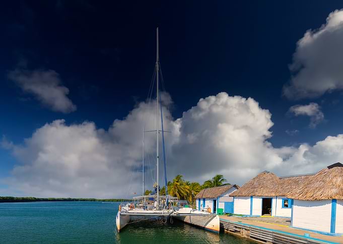 Catamaran docked at tropical pier, Caribbean