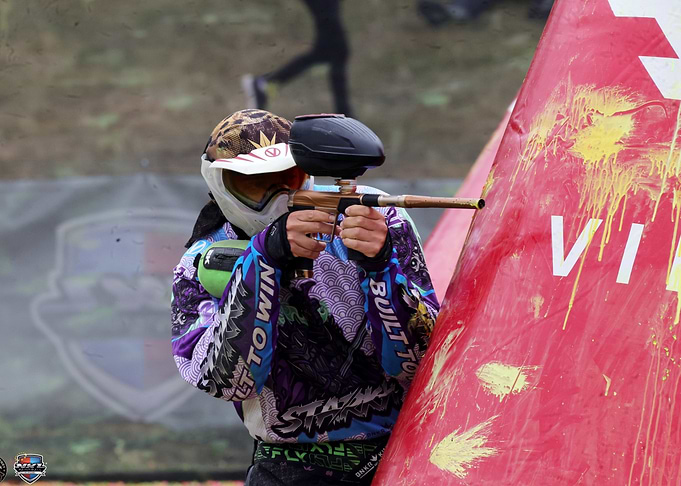 Paintball Player Aiming from Behind Cover