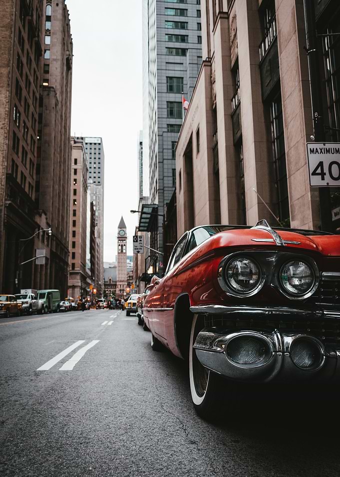 Red Classic Car in Cityscape