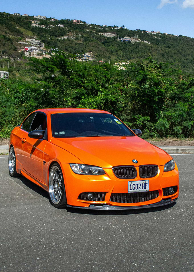 Orange BMW Coupe on Road