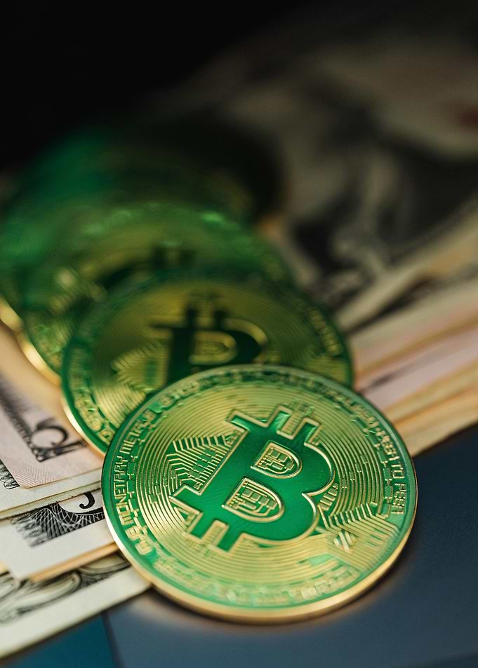 Green Bitcoin Coins on US Dollar Bills