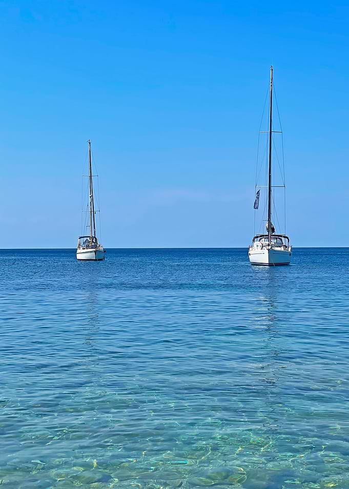 Two Sailboats on Calm Blue Water