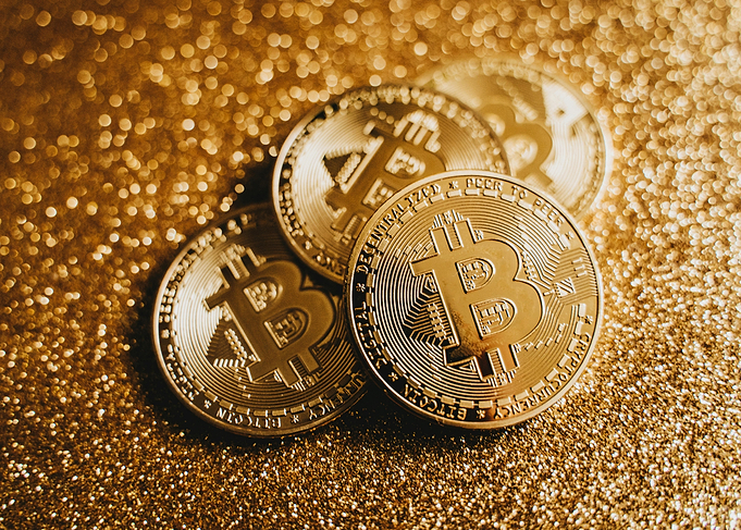 Golden Bitcoin Coins on Glitter Background