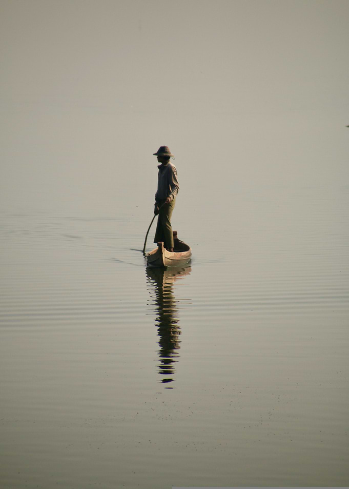 Man in boat on calm water