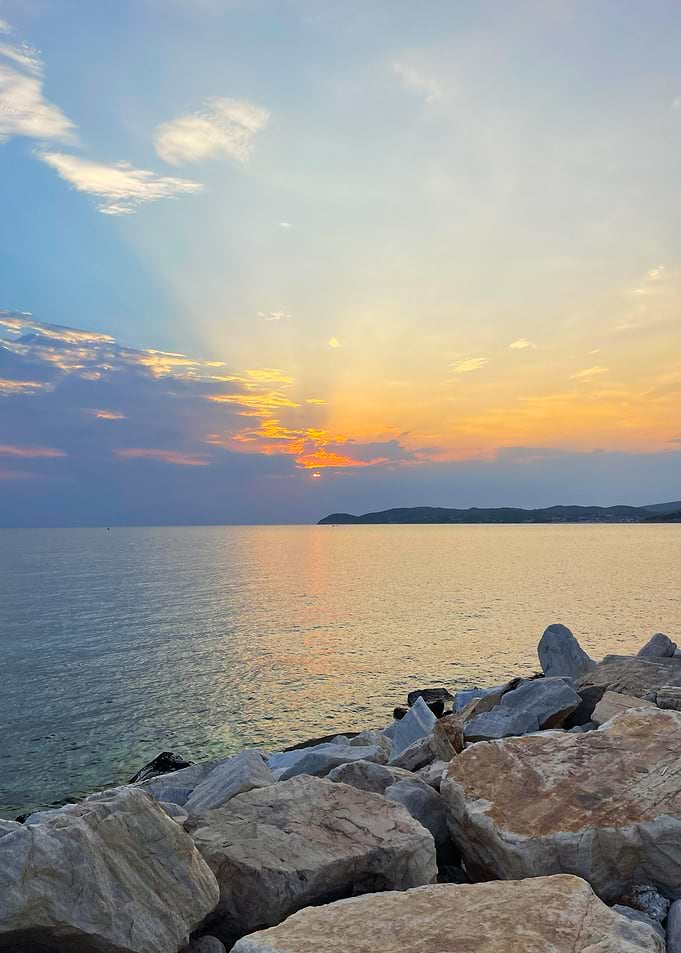 Sunset over the sea with rocks