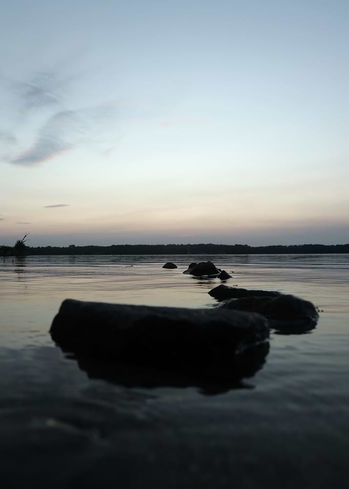 Rocks in water at dusk
