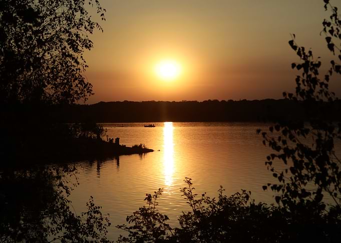 Golden Sunset Over Lake with Silhouettes
