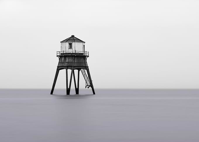 Black and White Lighthouse in the Sea