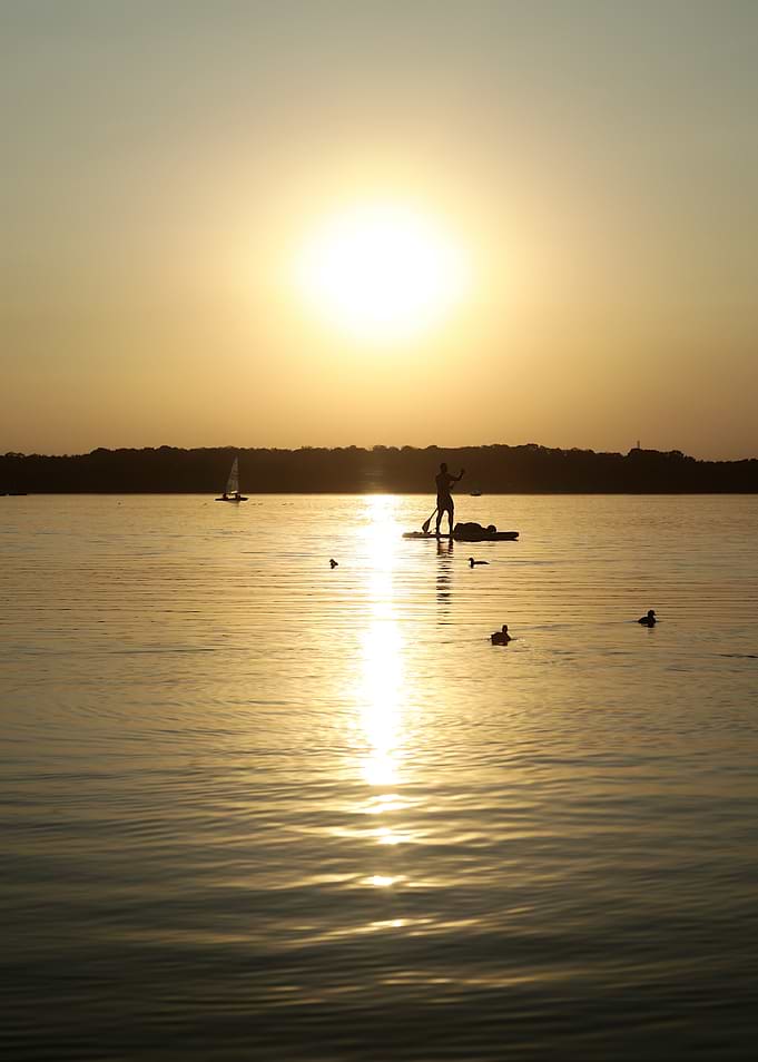 Sunset Paddleboarding on Calm Lake