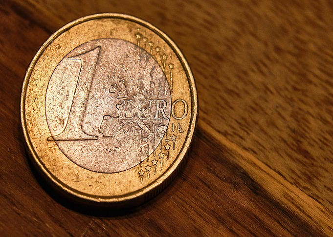 One Euro Coin on Wooden Surface