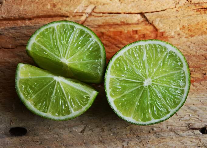 Fresh Lime Slices on Wooden Surface