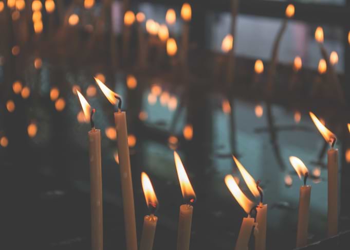 Candles burning in a dark space