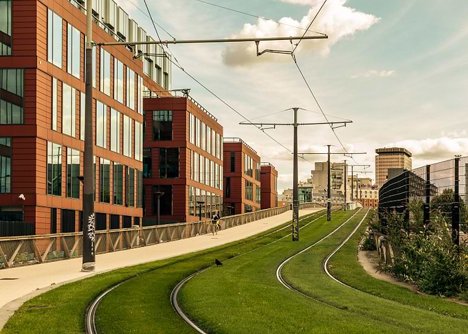 Modern Cityscape with Green Tram Tracks