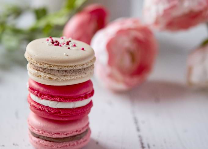 Stack of colorful macarons with flowers
