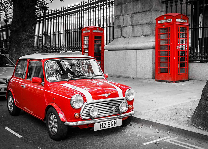 Red Mini Cooper with telephone booths