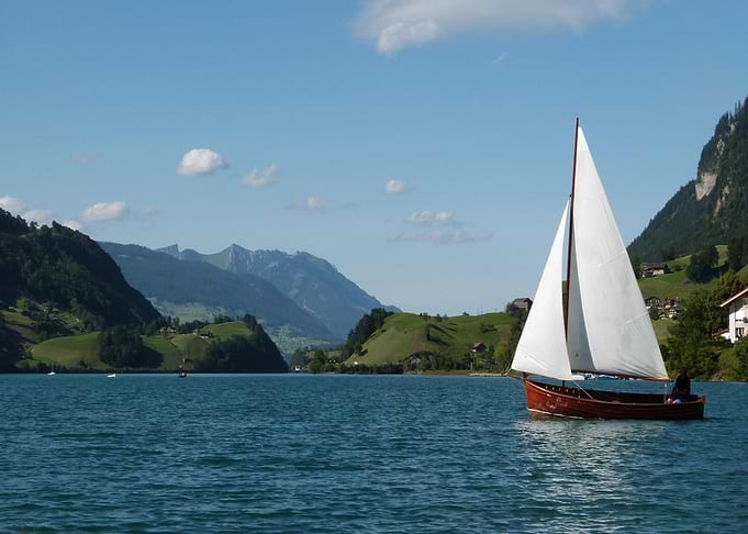 Sailboat on Lake with Mountain Backdrop