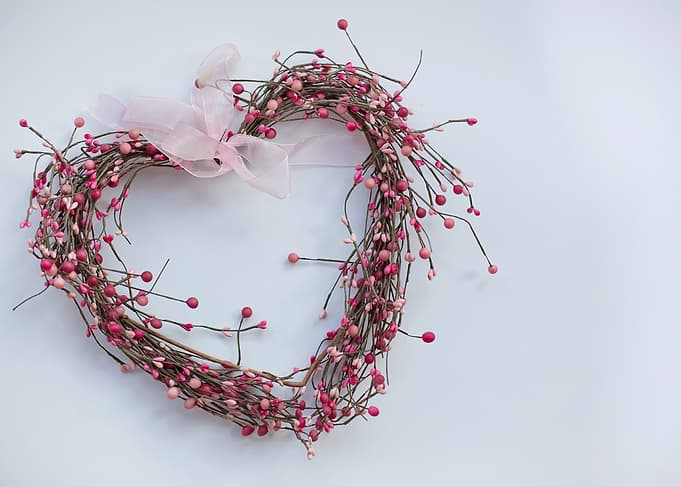 Heart-shaped berry wreath with pink ribbon