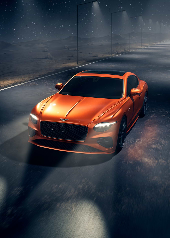 orange bentley on a night road
