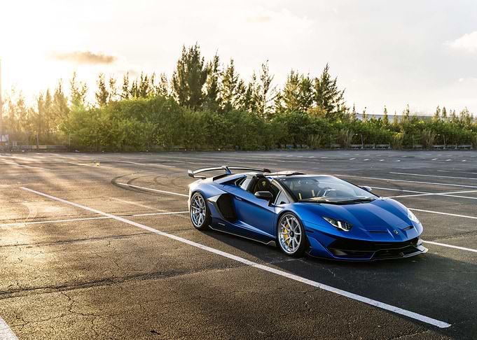 Blue Lamborghini Aventador on Asphalt