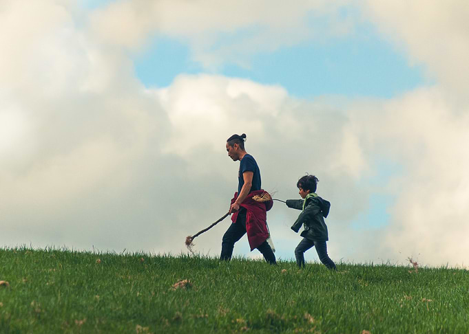 Father and Son Walking on Hill