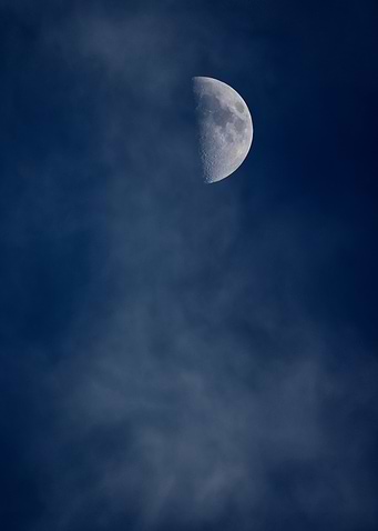 Half Moon in Cloudy Sky
