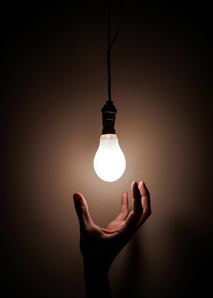 Hand Reaching for Light Bulb