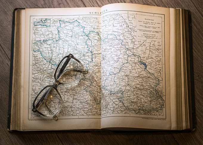 Open Map Book with Glasses