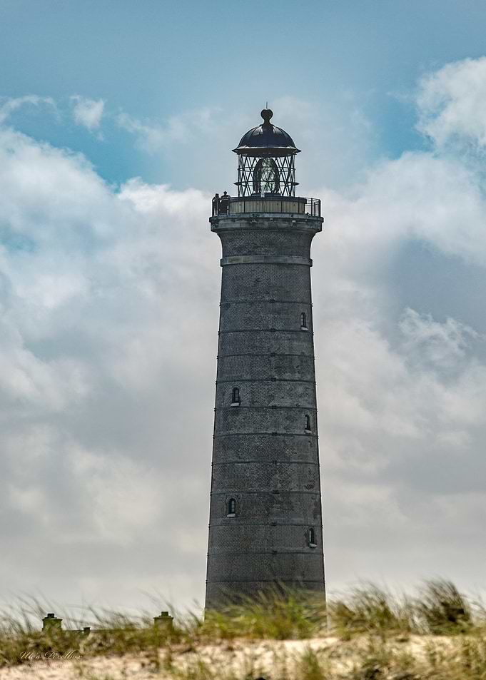 Tall Lighthouse Against Cloudy Sky